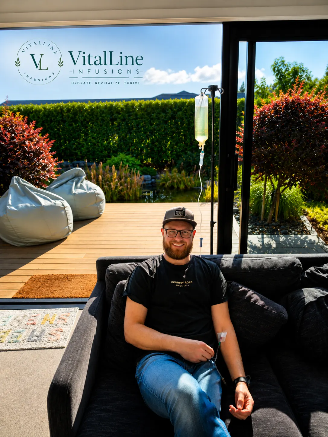 VitalLine Infusions founder relaxing on a couch at home while receiving an IV infusion